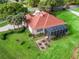 Aerial view of a single-Gathering home with a screened lanai, lush lawn, and landscaped garden beds at 39023 Griffin Lndg, Lady Lake, FL 32159