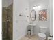 Charming bathroom features a pedestal sink, decorative mirror, and tiled walk-in shower at 39023 Griffin Lndg, Lady Lake, FL 32159