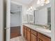 This bathroom features a double vanity, tile flooring, and a large mirror at 39023 Griffin Lndg, Lady Lake, FL 32159