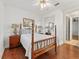 This bedroom features a hardwood floor, ceiling fan, and a mirrored closet at 39023 Griffin Lndg, Lady Lake, FL 32159