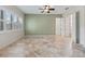 Tranquil bedroom with tile floors, soft green walls, plantation shutters, and ample natural light at 39023 Griffin Lndg, Lady Lake, FL 32159