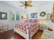 This bedroom features an interesting bedspread, ceiling fan, and many decorations at 39023 Griffin Lndg, Lady Lake, FL 32159