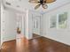 This bedroom features hardwood floors, mirrored closet, and a ceiling fan at 39023 Griffin Lndg, Lady Lake, FL 32159