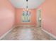 A dining room with a decorative chandelier, tile floors and a window with decorative shutters at 39023 Griffin Lndg, Lady Lake, FL 32159