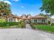 Beautiful home with stone accents, well-manicured landscaping, and a circular driveway, offering curb appeal and charm at 39023 Griffin Lndg, Lady Lake, FL 32159