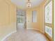 Elegant foyer with tile flooring, decorative glass door, and arched doorway, offering a grand entrance to the home at 39023 Griffin Lndg, Lady Lake, FL 32159