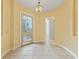 Elegant foyer with tile flooring, decorative glass door, and arched doorway, offering a grand entrance to the home at 39023 Griffin Lndg, Lady Lake, FL 32159
