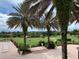 Scenic golf course view from a luxury home, framed by mature palm trees and lush landscaping at 39023 Griffin Lndg, Lady Lake, FL 32159