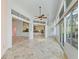 Bright great room featuring tile floors, high ceilings, and seamless transition to the kitchen and outdoor spaces at 39023 Griffin Lndg, Lady Lake, FL 32159