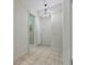 Hallway with tan tile flooring and decorative light fixture at 39023 Griffin Lndg, Lady Lake, FL 32159