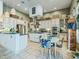 Bright eat-in kitchen featuring stainless steel appliances, center island, and ample cabinet space at 39023 Griffin Lndg, Lady Lake, FL 32159
