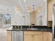 An open-concept kitchen featuring a stainless steel dishwasher, sink and pendant lights at 39023 Griffin Lndg, Lady Lake, FL 32159