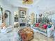 Stylishly decorated living room boasts a brick fireplace, tile flooring, and comfortable seating arrangements at 39023 Griffin Lndg, Lady Lake, FL 32159