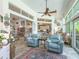 Inviting living room with comfortable seating, stylish decor, tile flooring, and bright natural light at 39023 Griffin Lndg, Lady Lake, FL 32159