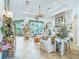 Stylishly decorated living room boasts a brick fireplace, tile flooring, and comfortable seating arrangements at 39023 Griffin Lndg, Lady Lake, FL 32159