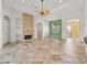 Spacious living area showcases tile flooring, a brick fireplace, and a ceiling fan for added comfort at 39023 Griffin Lndg, Lady Lake, FL 32159