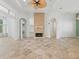 Bright living room features tile flooring, a brick fireplace, and an open layout for seamless entertaining at 39023 Griffin Lndg, Lady Lake, FL 32159