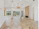 Spacious living room with large windows, fireplace, and tile flooring, perfect for entertaining or relaxing with Gathering at 39023 Griffin Lndg, Lady Lake, FL 32159