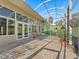 Enclosed patio features brick flooring and a scenic outdoor view at 39023 Griffin Lndg, Lady Lake, FL 32159
