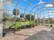 Screened-in patio featuring brick flooring and lush landscaping at 39023 Griffin Lndg, Lady Lake, FL 32159