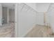 Well-organized walk-in closet featuring wood look floors and ample shelving for storage solutions at 39023 Griffin Lndg, Lady Lake, FL 32159