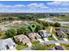An aerial view of a community with lush green landscaping, and a scenic pond in the background at 4717 Inverness Dr, Leesburg, FL 34748