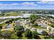 An aerial view of a community showcasing the lake and residential area with mature trees and verdant landscapes at 4717 Inverness Dr, Leesburg, FL 34748