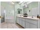 Bright bathroom features a double sink vanity, soaking tub, and walk-in shower at 4717 Inverness Dr, Leesburg, FL 34748