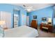 Brightly lit bedroom with natural light, vaulted ceilings and cool, modern colors at 4717 Inverness Dr, Leesburg, FL 34748