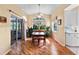 Charming dining area filled with natural light, wood floors, and a view to the screened lanai at 4717 Inverness Dr, Leesburg, FL 34748