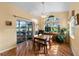 Bright dining area with wood floors, a ceiling fan, and large windows overlooking the yard at 4717 Inverness Dr, Leesburg, FL 34748