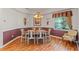 Formal dining room featuring hardwood floors, elegant lighting, and large window with natural light at 4717 Inverness Dr, Leesburg, FL 34748