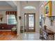 Inviting foyer featuring decorative glass front door, tile flooring, high ceilings, and natural light at 4717 Inverness Dr, Leesburg, FL 34748