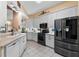 Modern kitchen with stainless steel appliances, white cabinetry, and ample counter space at 4717 Inverness Dr, Leesburg, FL 34748