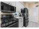 Updated kitchen featuring modern black appliances, ample counter space, and white cabinets at 4717 Inverness Dr, Leesburg, FL 34748