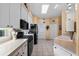 Bright kitchen featuring white cabinets, modern appliances, and a sunlit skylight at 4717 Inverness Dr, Leesburg, FL 34748