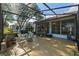 Screened lanai featuring outdoor seating and potted plants at 4717 Inverness Dr, Leesburg, FL 34748