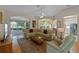 Spacious living room featuring hardwood floors, cozy furniture, and large windows with natural light at 4717 Inverness Dr, Leesburg, FL 34748