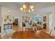 Bright open concept: living room adjacent to dining room, with hardwood flooring and chandelier lighting at 4717 Inverness Dr, Leesburg, FL 34748