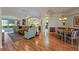 Bright living room with hardwood floors, comfortable furniture, and access to screened-in patio at 4717 Inverness Dr, Leesburg, FL 34748
