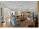 Spacious living room with wood flooring, fireplace, and an open layout to the dining area at 4717 Inverness Dr, Leesburg, FL 34748