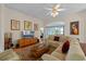 Open-concept living room with comfortable seating, hardwood floors, and access to outdoor patio area at 4717 Inverness Dr, Leesburg, FL 34748