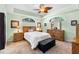 Serene main bedroom with tray ceiling, carpet, and a large dresser at 4717 Inverness Dr, Leesburg, FL 34748