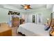 Relaxing main bedroom featuring a ceiling fan, neutral tones, and access to the lanai at 4717 Inverness Dr, Leesburg, FL 34748