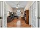 Bright home office featuring wood floors, natural light, and ample desk and storage space at 4717 Inverness Dr, Leesburg, FL 34748