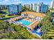 Stunning aerial perspective of the community pool with cabanas and building in the background at 5300 S Atlantic Ave # 16-202, New Smyrna Beach, FL 32169
