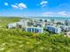 Distant aerial shot of a condo community near the beach, with landscaping and ponds at 5300 S Atlantic Ave # 16-202, New Smyrna Beach, FL 32169