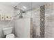 Bathroom featuring glass shower with decorative tile and a toilet at 5300 S Atlantic Ave # 16-202, New Smyrna Beach, FL 32169