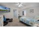 Bright bedroom with a TV, sitting chair and workspace with a view at 5300 S Atlantic Ave # 16-202, New Smyrna Beach, FL 32169