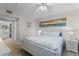 Inviting bedroom featuring coastal decor, wood floors, and serene ambiance at 5300 S Atlantic Ave # 16-202, New Smyrna Beach, FL 32169